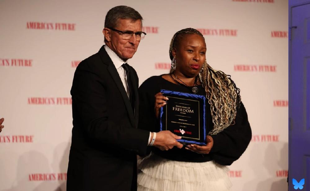 General Michael Flynn presenting Jaguar Wright with the Defender of Freedom Award - via BlueSky