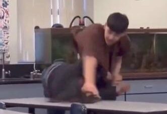 Jehue Middle School - Latino male student slams Black female student onto desk - screenshot