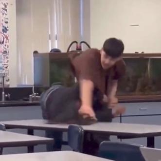 Jehue Middle School - Latino male student slams Black female student onto desk - screenshot