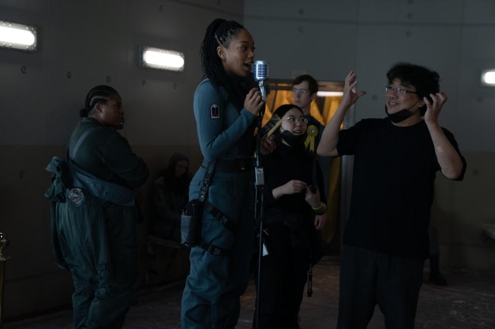Naomi Ackie and Director Bong Joon-ho behind the scenes of 'MICKEY 17'' - via Warner Bros. Pictures