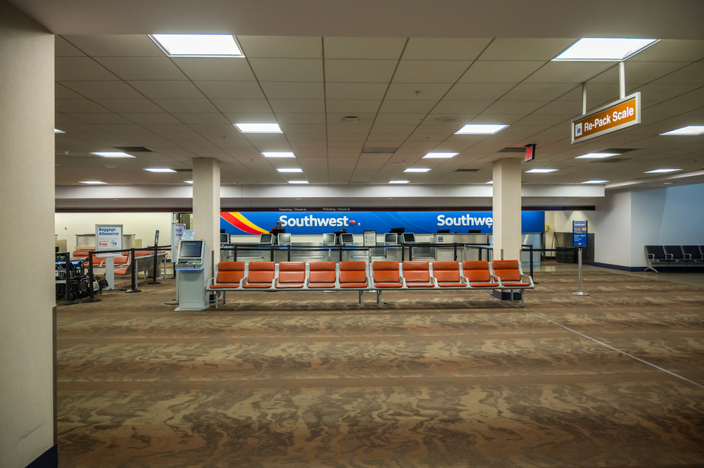 Southwest Airlines: Bag Fees, Service Drop = Customer Backlash // Southwest Airlines (gate-waiting area) - Depositphotos