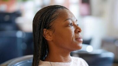 African American woman getting hair rinsed - via Grok AI