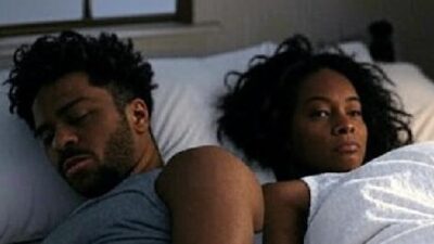 Black Couple in bed not happy with each other - via Grok AI