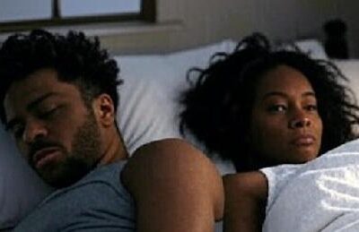 Black Couple in bed not happy with each other - via Grok AI