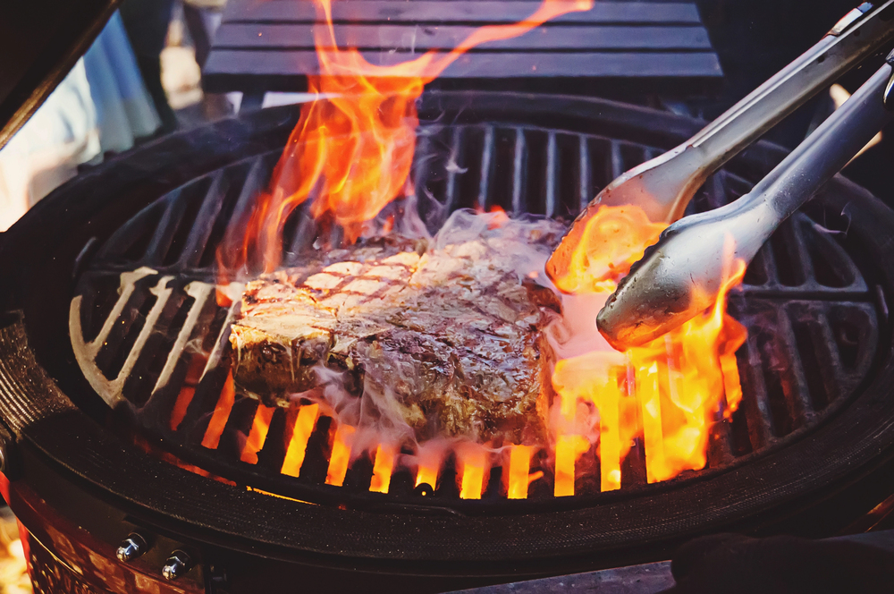 Steak on the grill with flames