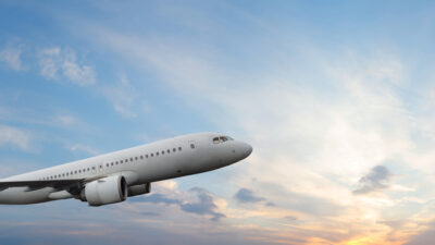 Passenger airplane flying during sunset sky