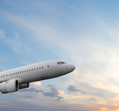 Passenger airplane flying during sunset sky