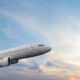 Passenger airplane flying during sunset sky