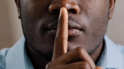 Keeping A Secret - African American Male - Depositphotos