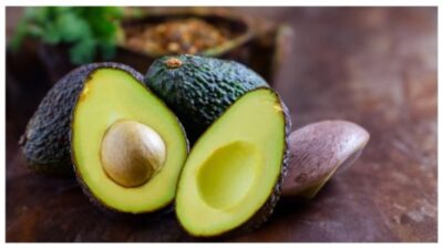 Avocado in basket isolated on white with vitamin B