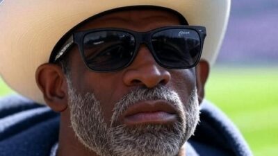 Deion Sanders (concerned look) - via Grok AI