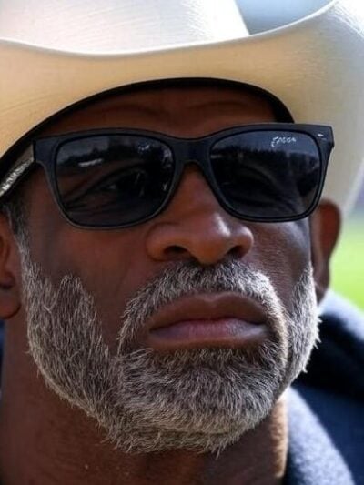 Deion Sanders (concerned look) - via Grok AI