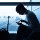person at airport looking a smartphone