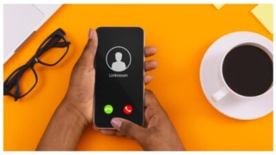 Female Hand Holding Phone With Incoming Call From Unknown caller