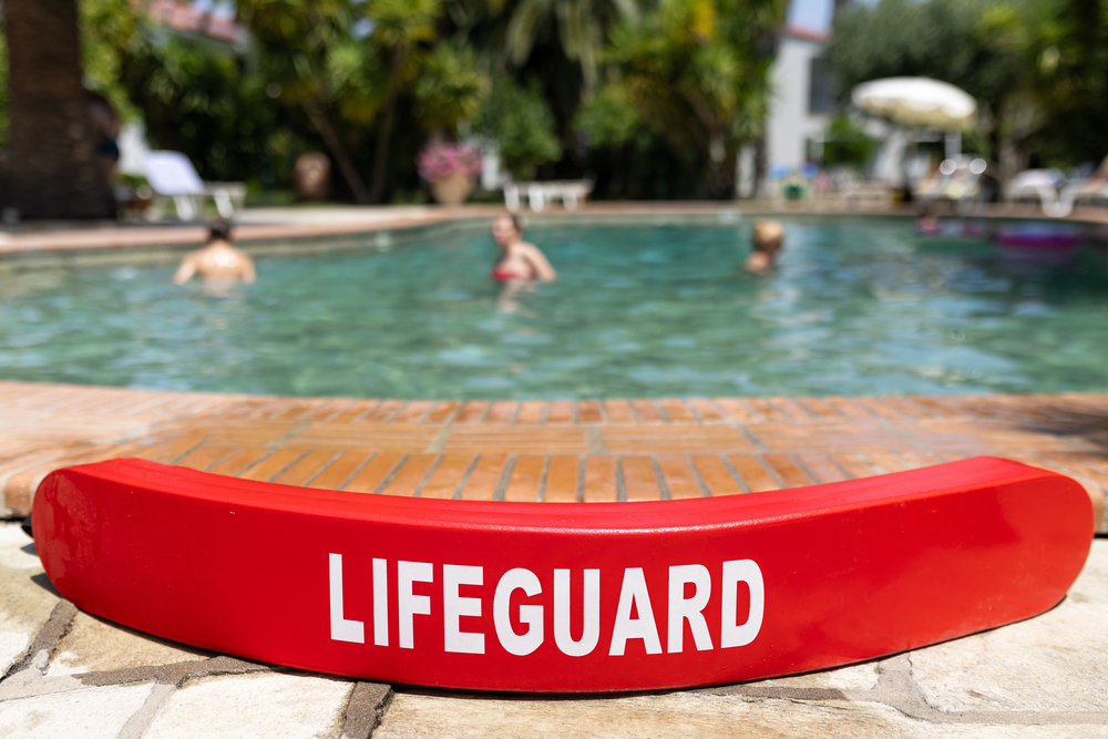 Lifeguard standing in the sand. lifeguard float. 