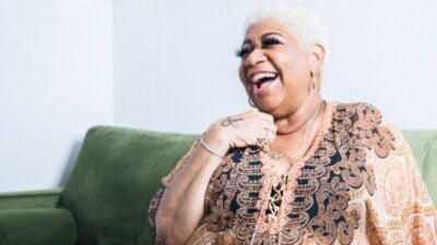 Luenell laughing in a promotional photo for her Flappers Comedy Club residency and stand-up showcase.