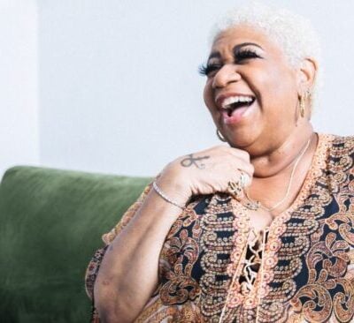 Luenell laughing in a promotional photo for her Flappers Comedy Club residency and stand-up showcase.