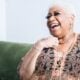 Luenell laughing in a promotional photo for her Flappers Comedy Club residency and stand-up showcase.