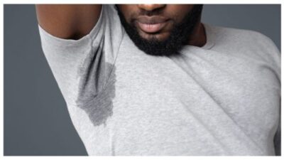 Black man sweating under armpit