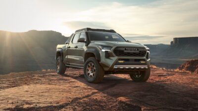 pick up truck green parked on desert soil