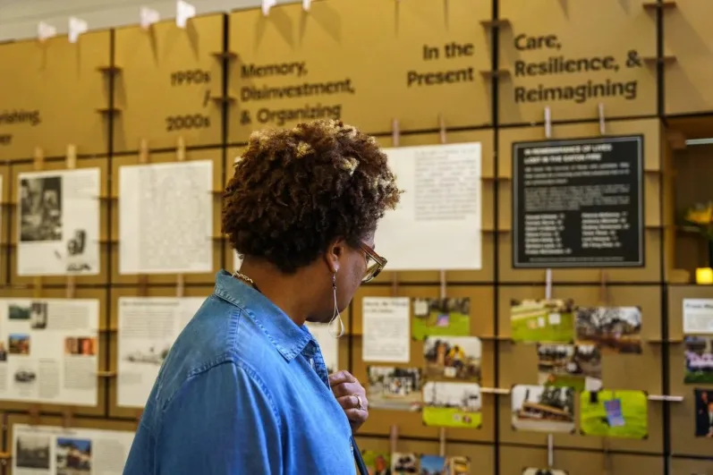 An Eaton Fire victim examines a display of the Black history of Altadena and Pasadena Photo by Solomon O. Smith
