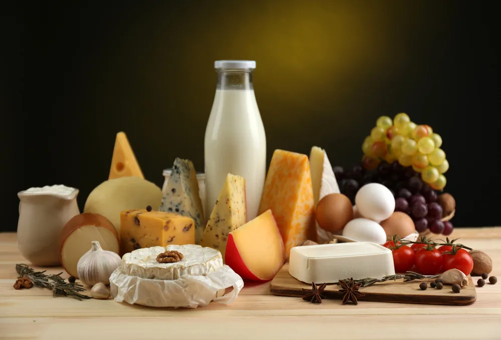 Tasty dairy products on wooden table