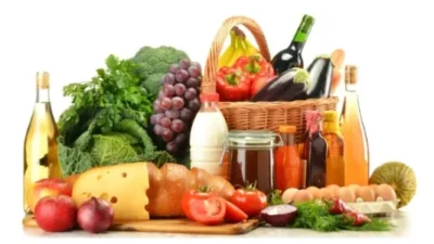 Groceries in wicker basket including vegetables and fruits