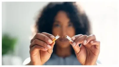Woman breaking down cigarette to pieces