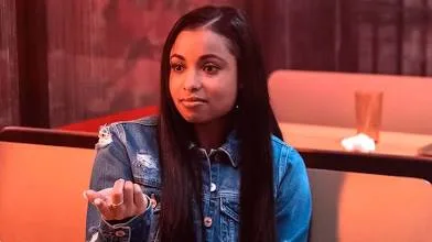 Hannaha Hall sitting at a diner in a denim jacket during a scene from &ldquo;The Chi&rdquo;