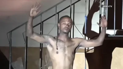 Marcus Evans hands up - screenshot