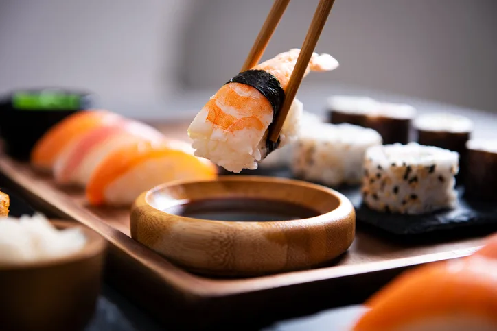 Chopstick with nigiri sushi piece stock photo
