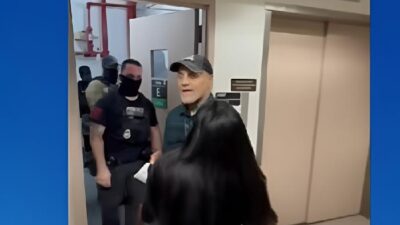 Woman about to be shoved to the ground by male ICE Agent - via CBS News screenshot