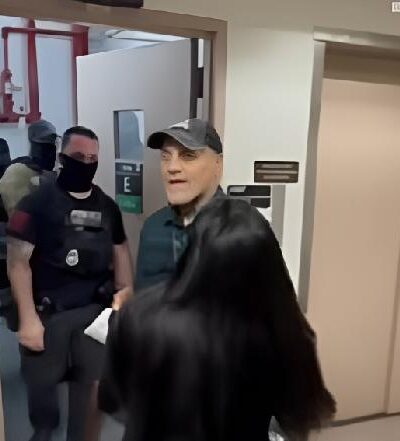 Woman about to be shoved to the ground by male ICE Agent - via CBS News screenshot