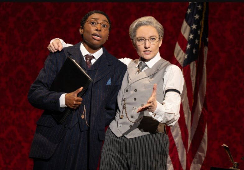 Brandi Porter (Dudley Malone) and Jenny Ashman (President Woodrow Wilson) in the First National Touring Company of SUFFS. Photo by Joan Marcus, 2025.