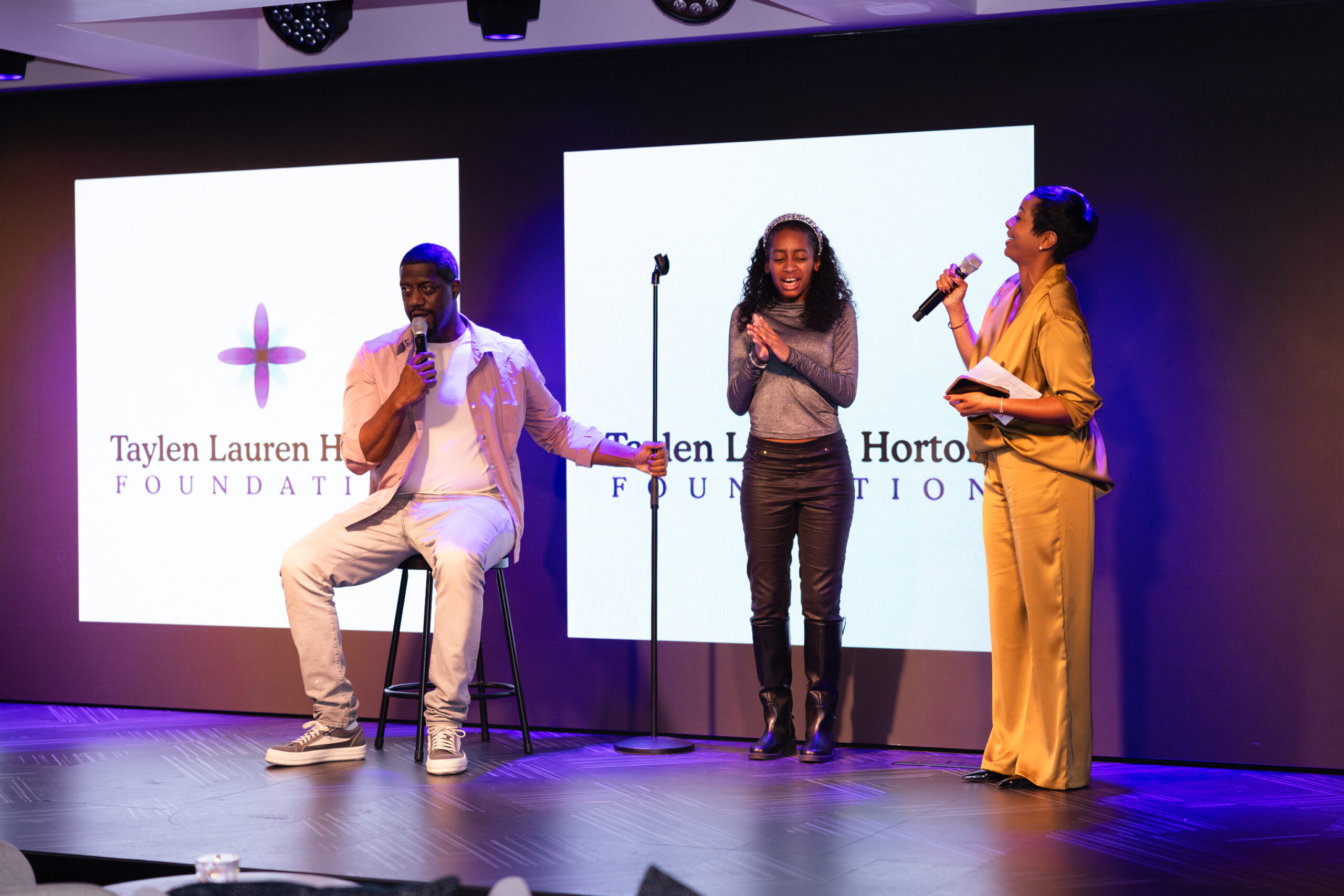 Spank and Jenece address the crowd about the charity with their daughter Taylen joining them.