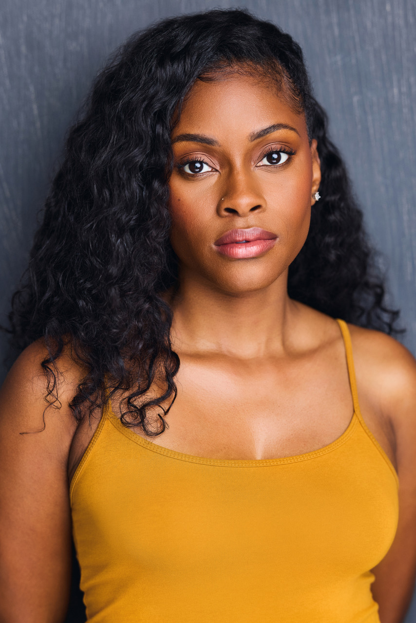 Headshot of actress Jasmine Sargent in a mustard tank top.
