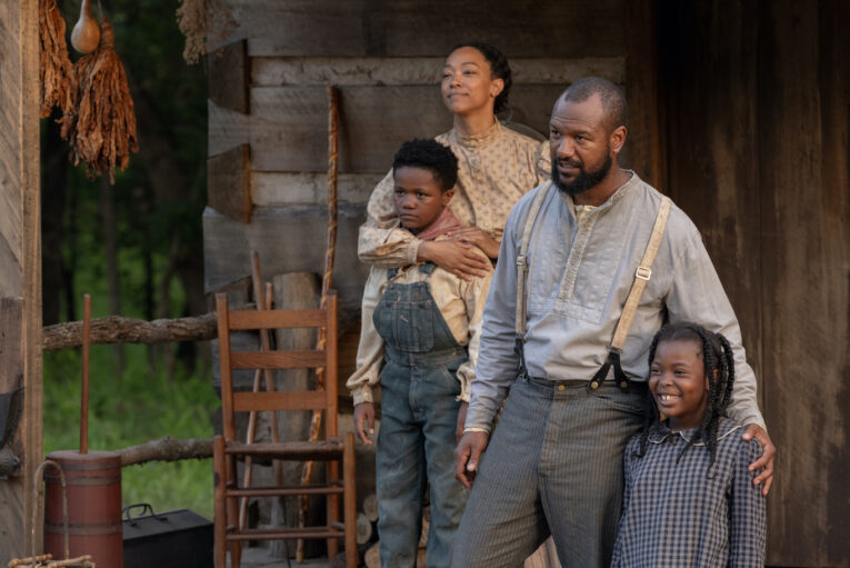 Sonequa Martin-Green and Kenric Green portray Rose and Joe Rector standing with the young actors portraying their children in a scene from &ldquo;Sarah&rsquo;s Oil.&rdquo;