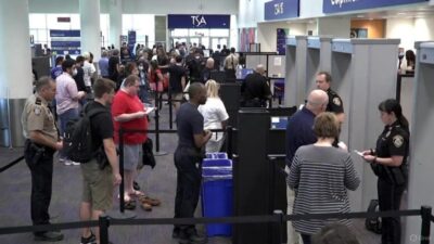 Busy TSA checkpoint at an airport returning to normal after government reopening - via GrokAI