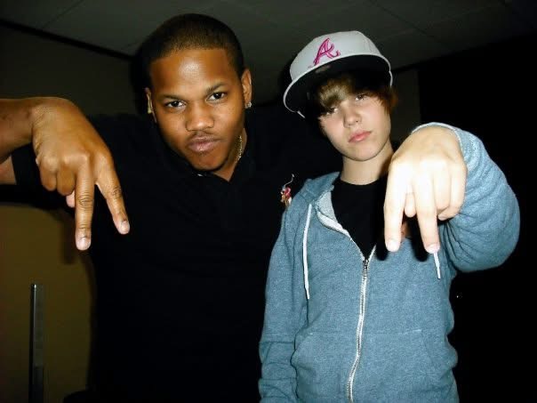 Calvin Spann posing with a young Justin Bieber early in Bieber’s career.
