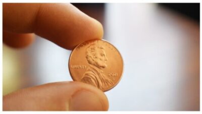 person holding a penny