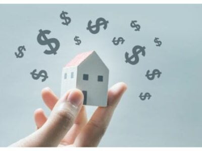 House model on human hands with dollar icon