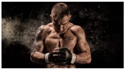 Mixed martial artist posing on a black background