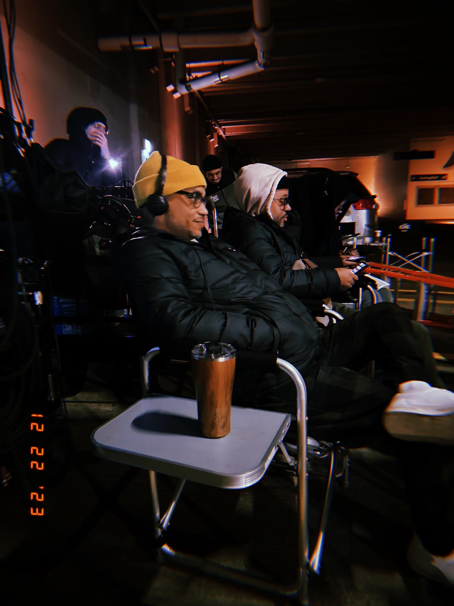 Deondray Gossfield and Quincy LeNear Gossfield review footage on playback monitors during a production.
