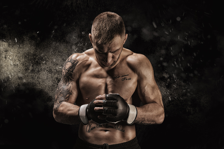 Mixed martial artist posing on a black background