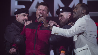 Glen Powell (red outfit), and Colman Domingo star in Paramount Pictures' "THE RUNNING MAN."