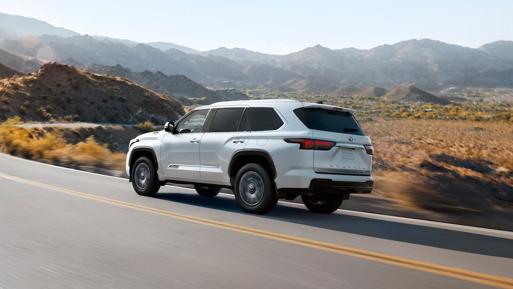 White 2025 Toyota Sequoia 1794 Hybrid on the road