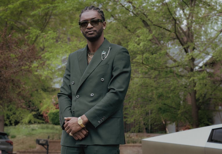 Jay Will full-body outdoor portrait (green suit)