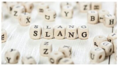 Slang word written on wood block. stock photo