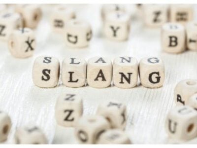 Slang word written on wood block. stock photo