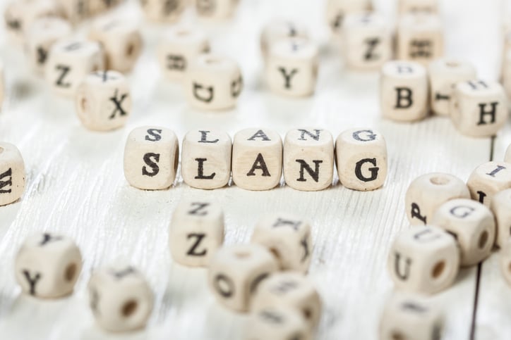 Slang word written on wood block. stock photo